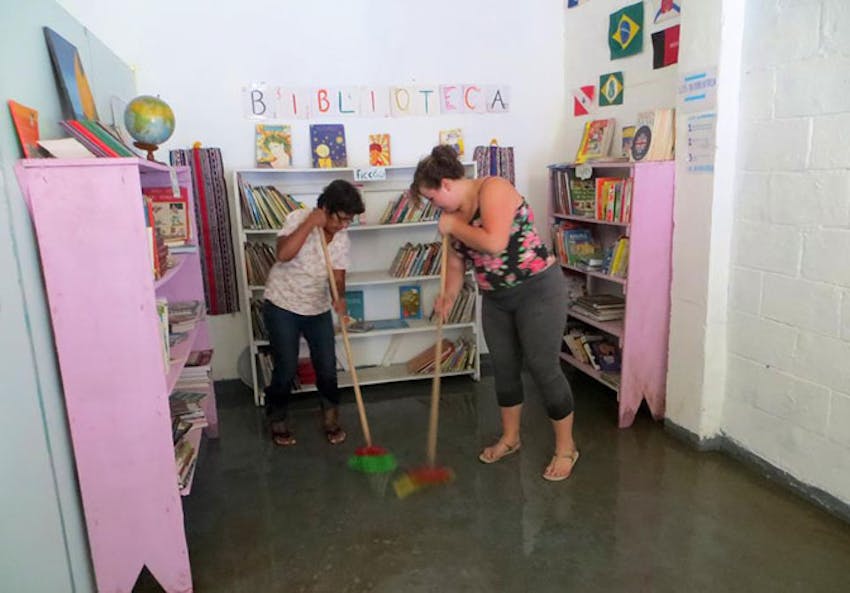 Cleaning the library in Brazil with IVHQ as a volunteer