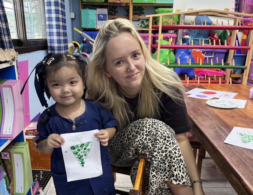 Jessica Chadwick with a young girl during a childcare volunteer project in Vietnam