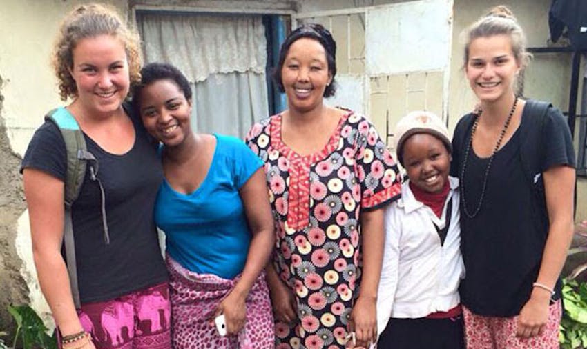 IVHQ volunteers with their host family in Tanzania with IVHQ