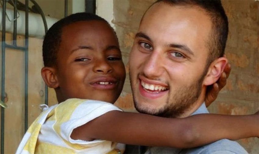 IVHQ volunteer Zac with a local child in Tanzania