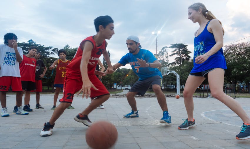 IVHQ volunteer playing basketball with children
