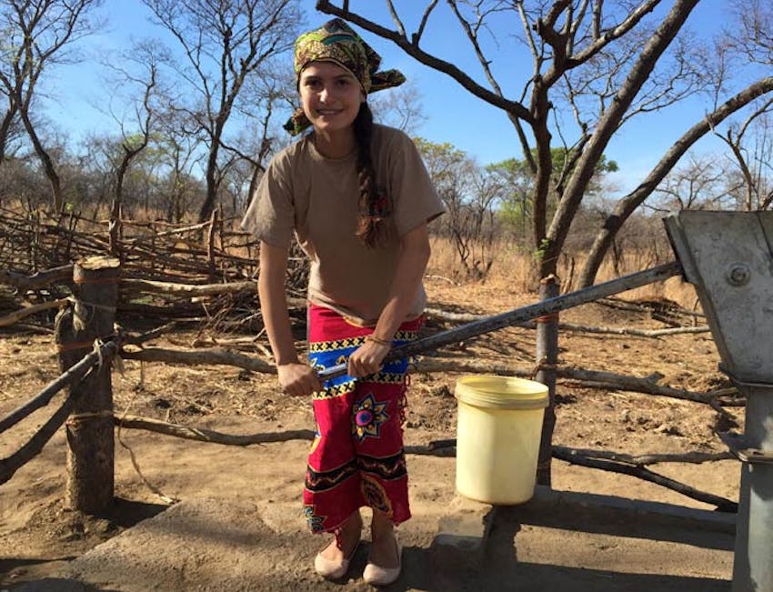 An IVHQ volunteer collecting water in a Zambian Village