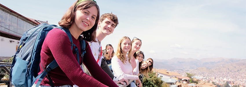 A group of volunteers sitting outdoors, smiling