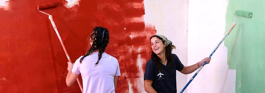 Volunteers painting walls