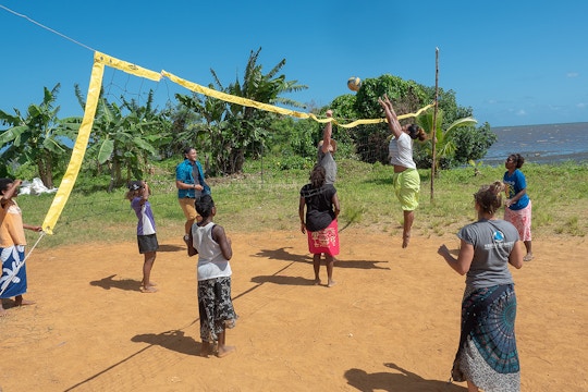 IVHQ Volunteers and children playing volleyball on the Sports Education in Fiji