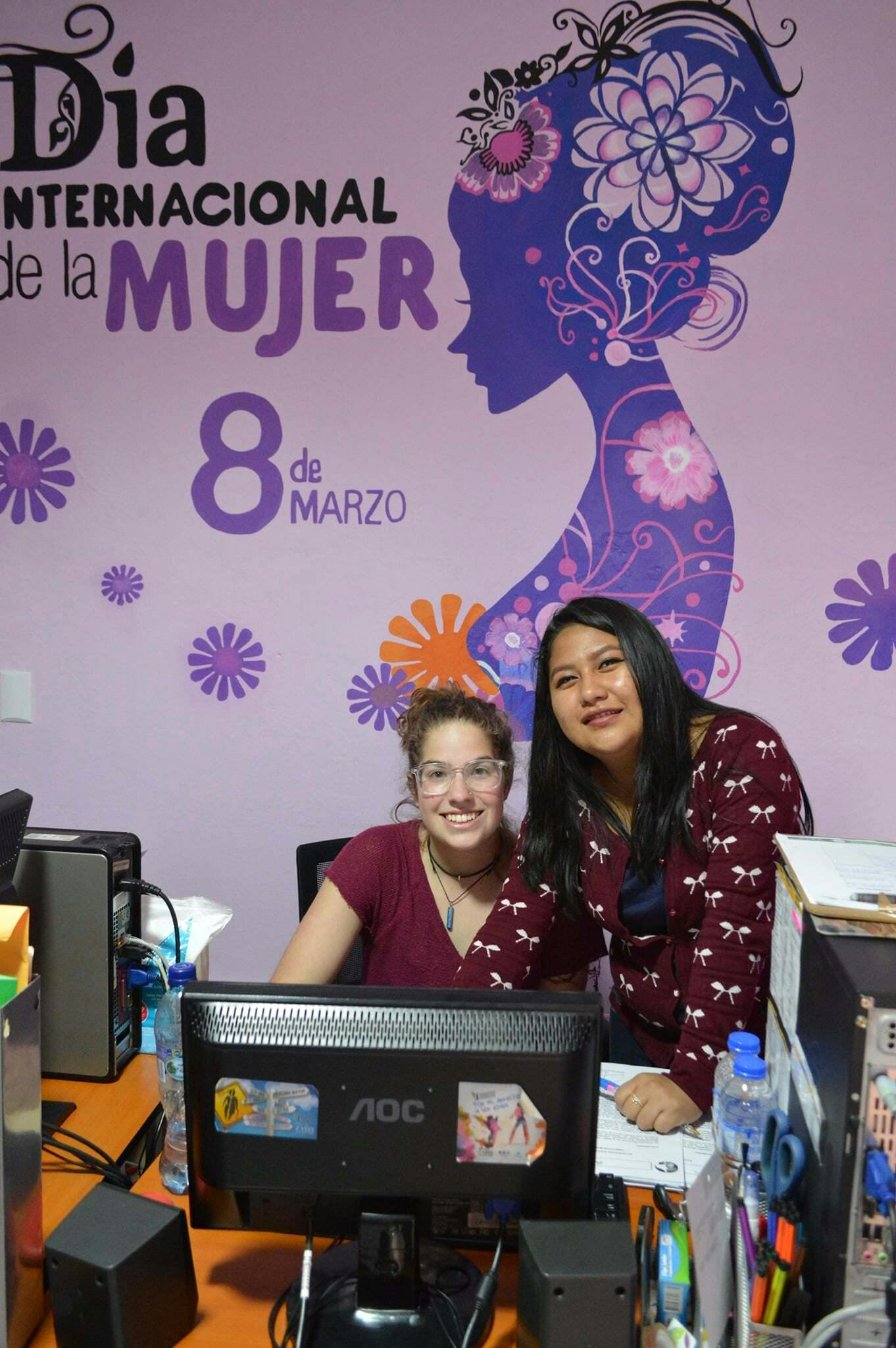 An IVHQ Volunteer and local organisation staff working on a workshop for local women