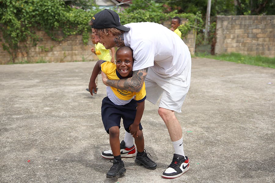 IVHQ volunteer playing with kid at the Jamaica Sports Development project