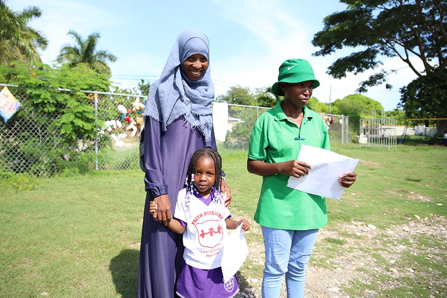 Local staff with student at the IVHQ Teaching and School Support project in Jamaica