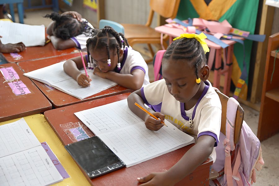 Students learning in class the IVHQ Teaching and School Support project in Jamaica