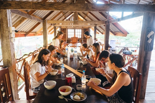 IVHQ volunteers enjoy a meal in Laos