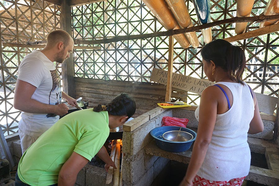 Volunteer preparing meal with others for local kids in need while volunteering healthcare with IVHQ in Philippines