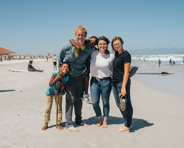 IVHQ volunteers on Muizenburg Beach in South Africa with IVHQ