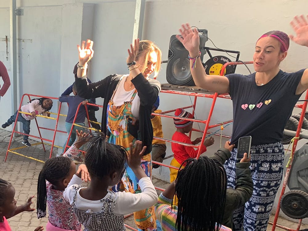 IVHQ volunteer dancing with kids on the Childcare project in South Africa