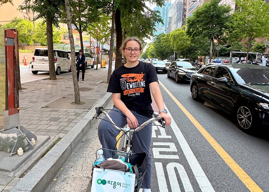 Volunteers riding a bike in South Korea during their free time at IVHQ