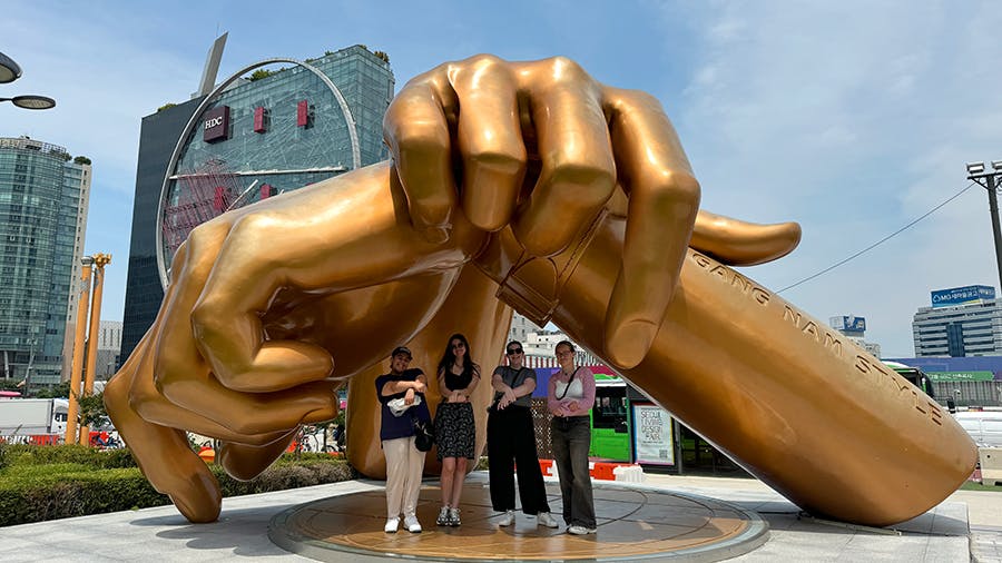 Visiting Gangnam style sculpture symbol mark during free time at IVHQ volunteer week