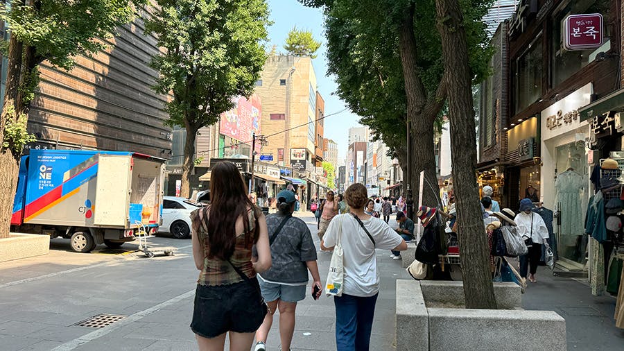 IVHQ volunteer walking on a street in Seould during their free time volunteering