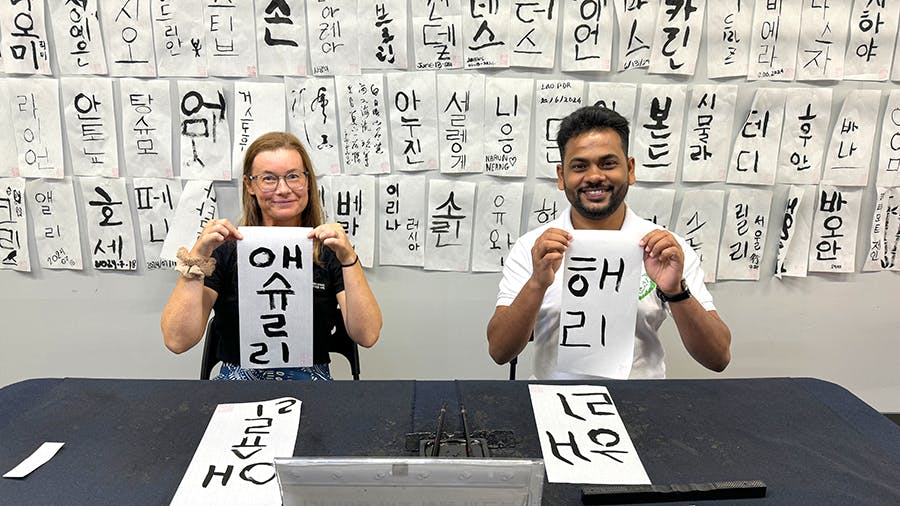 Volunteers writing caligraphy at the IVHQ Culture week volunteering in Seoul, South Korea