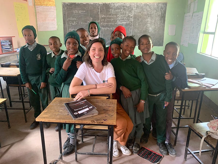 A group of students in Tanzania with an IVHQ teaching volunteer