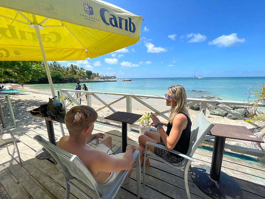IVHQ voluteers having a chat and sitting by the beach in Trinidad and Tobago on their IVHQ weekend