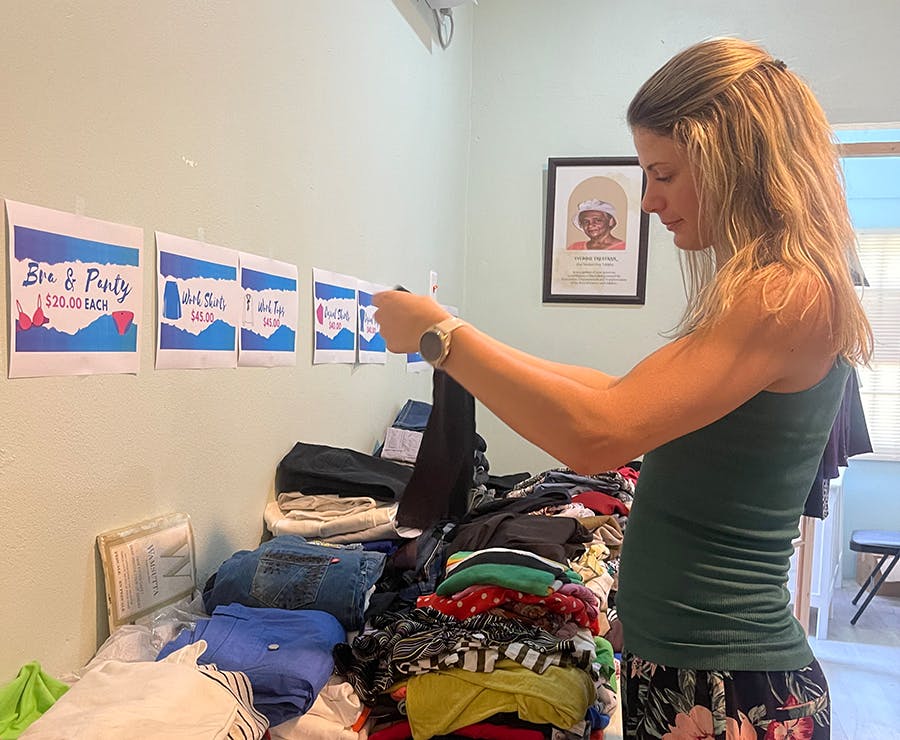 IVHQ volunteer folding clothes at the women's empowerment project in Trinidad and Tobago