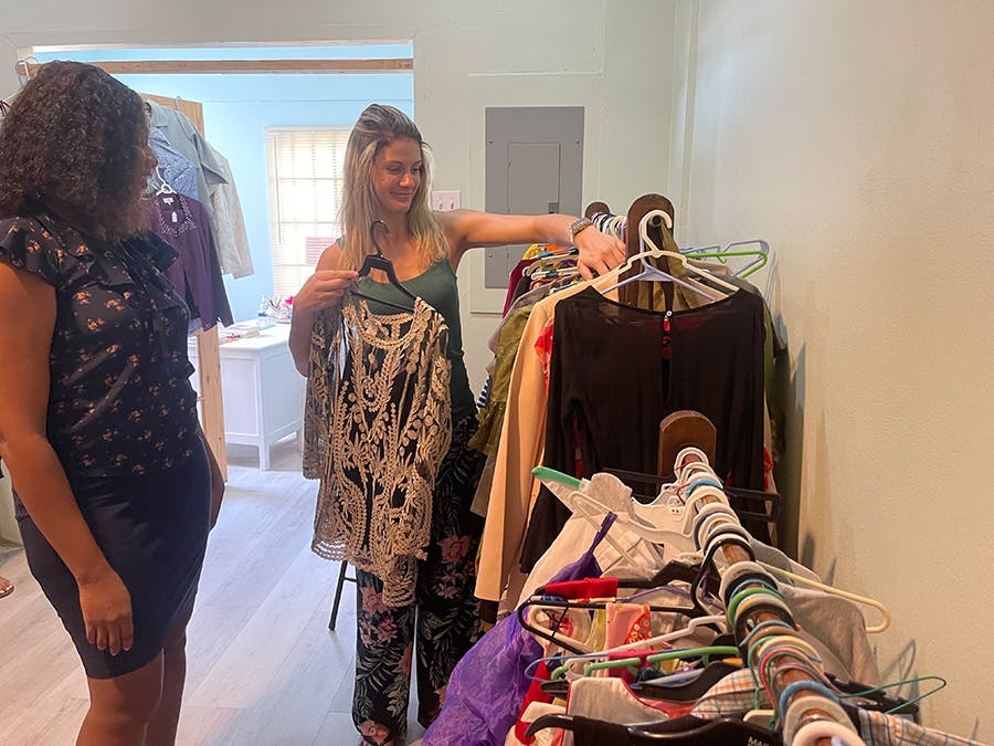 Volunteer organizing clothes at Women's Empowerment project in Trinidad and Tobago with IVHQ