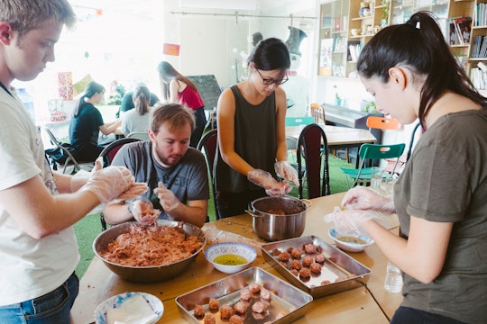 Volunteers preparing food on the Food Outreach volunteers with IVHQ in Vietnam